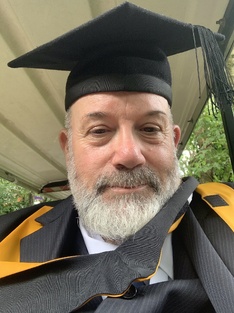In the robes of a Master of Arts, Falmouth University