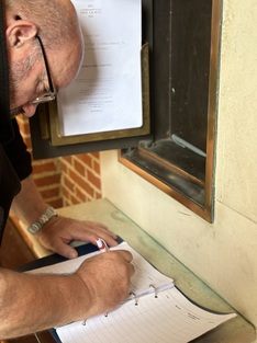 The author, Shaun Parkes, signing the visitor book at Jonkerbos Cemetery, Nijmegen. 